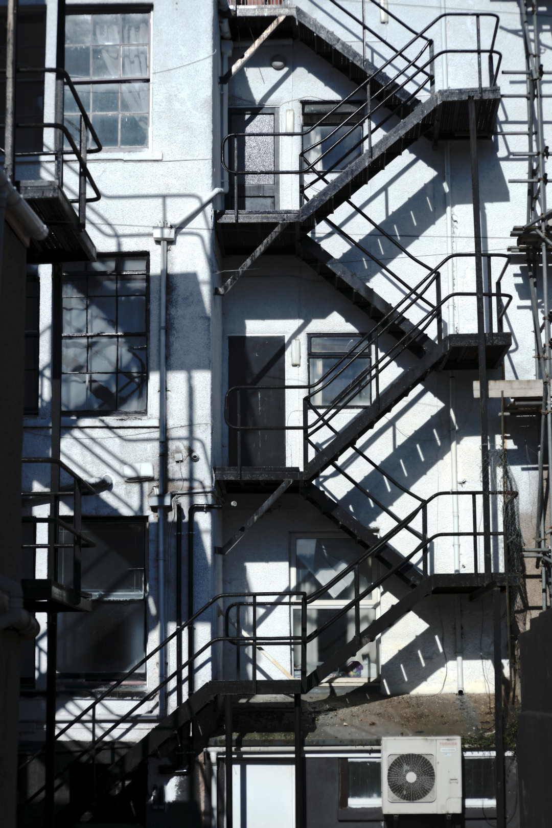 Criss-crossing stairs on the side of a building