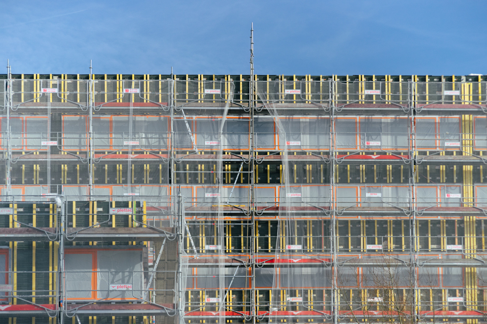Repeated colored forms on a building façade in the Yvette valley